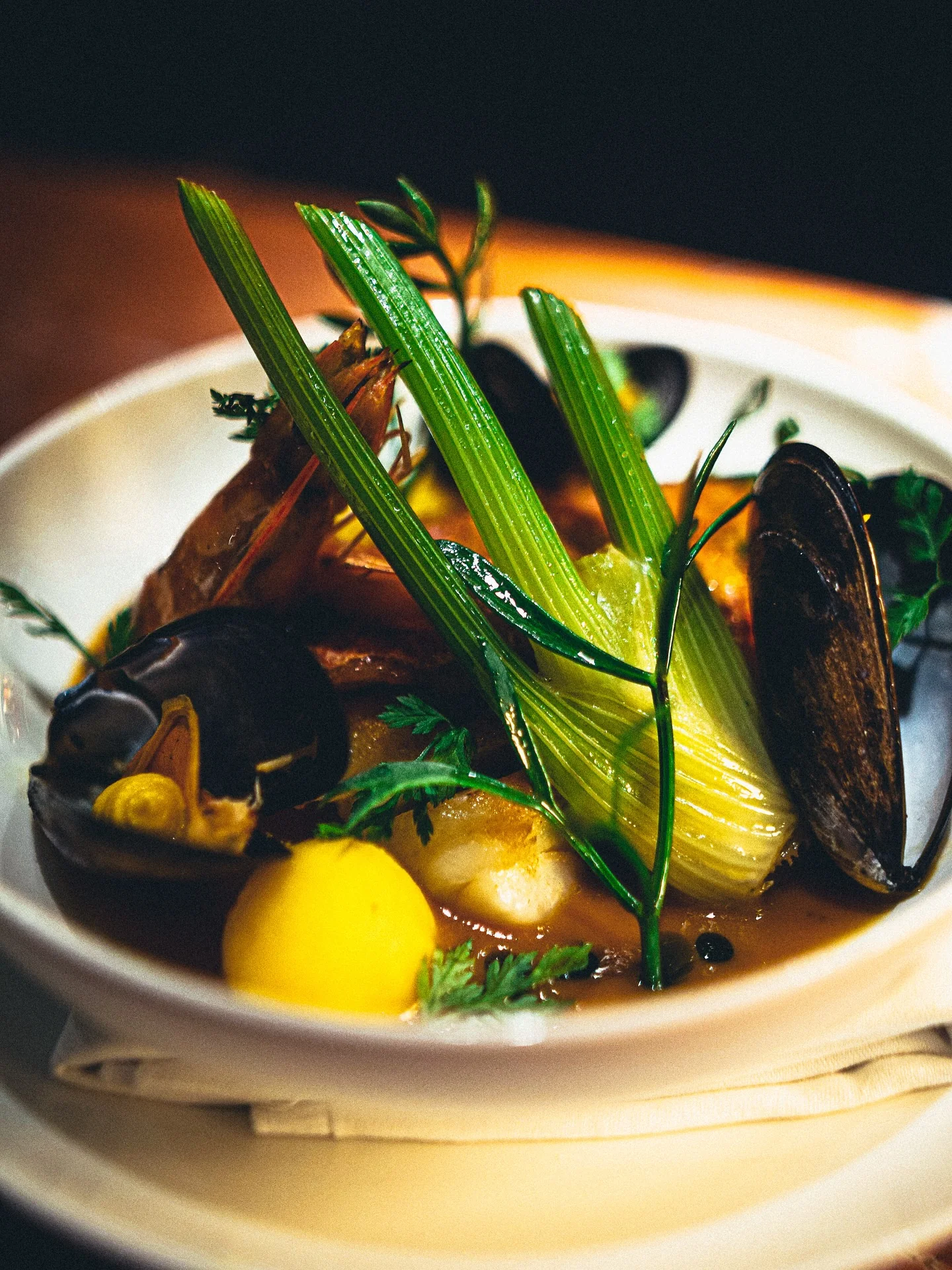 A seafood course with green vegetables