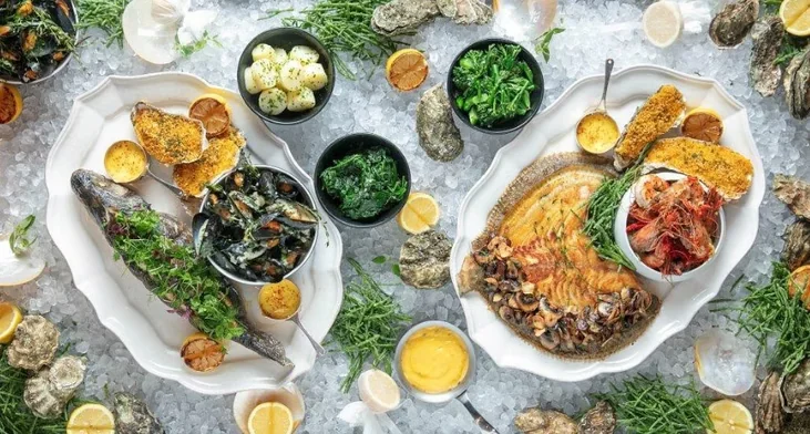 Sharing platters and side dishes arranged across a table